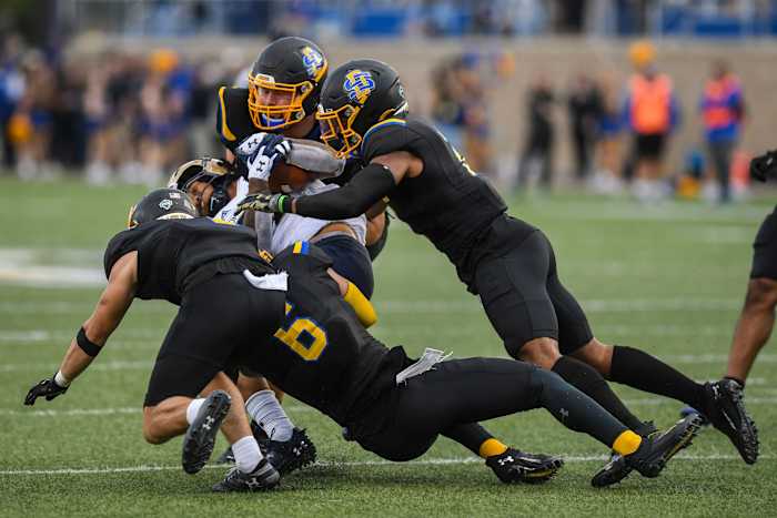 South Dakota State football players try to tackle a Montana State player at Dana J. Dykhouse Stadium in Brookings, South Dakota on Saturday, Sept. 9, 2023.